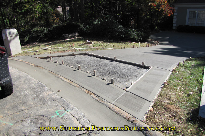 New concrete driveway with inset for stone entrance.